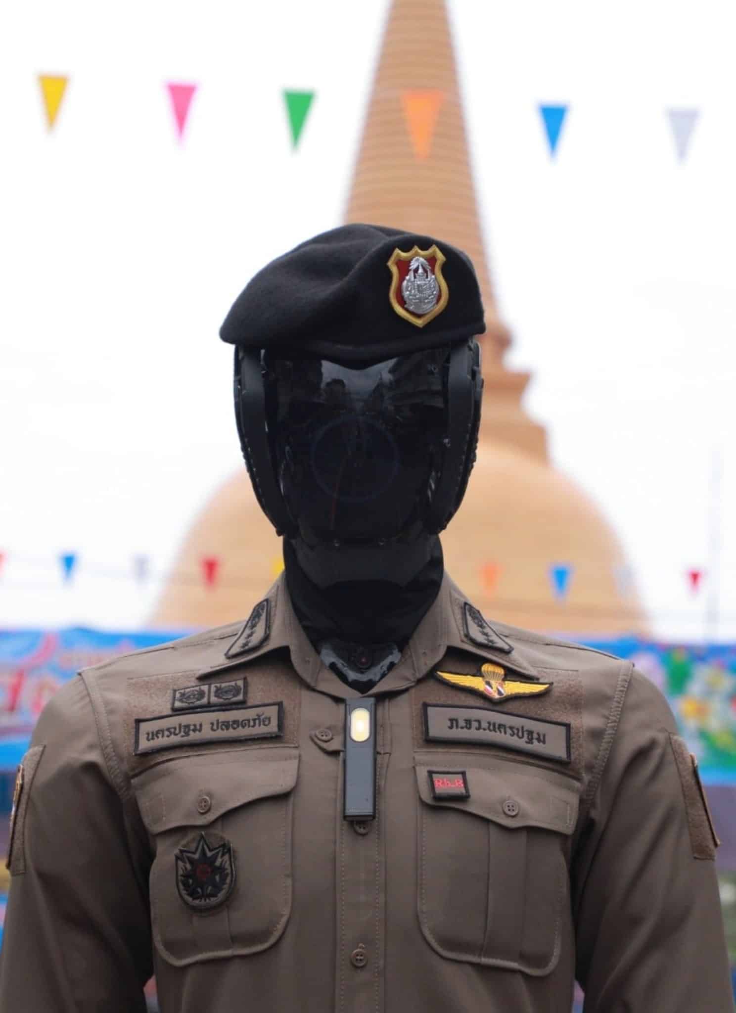Robot cop dressed in Thai police uniform.