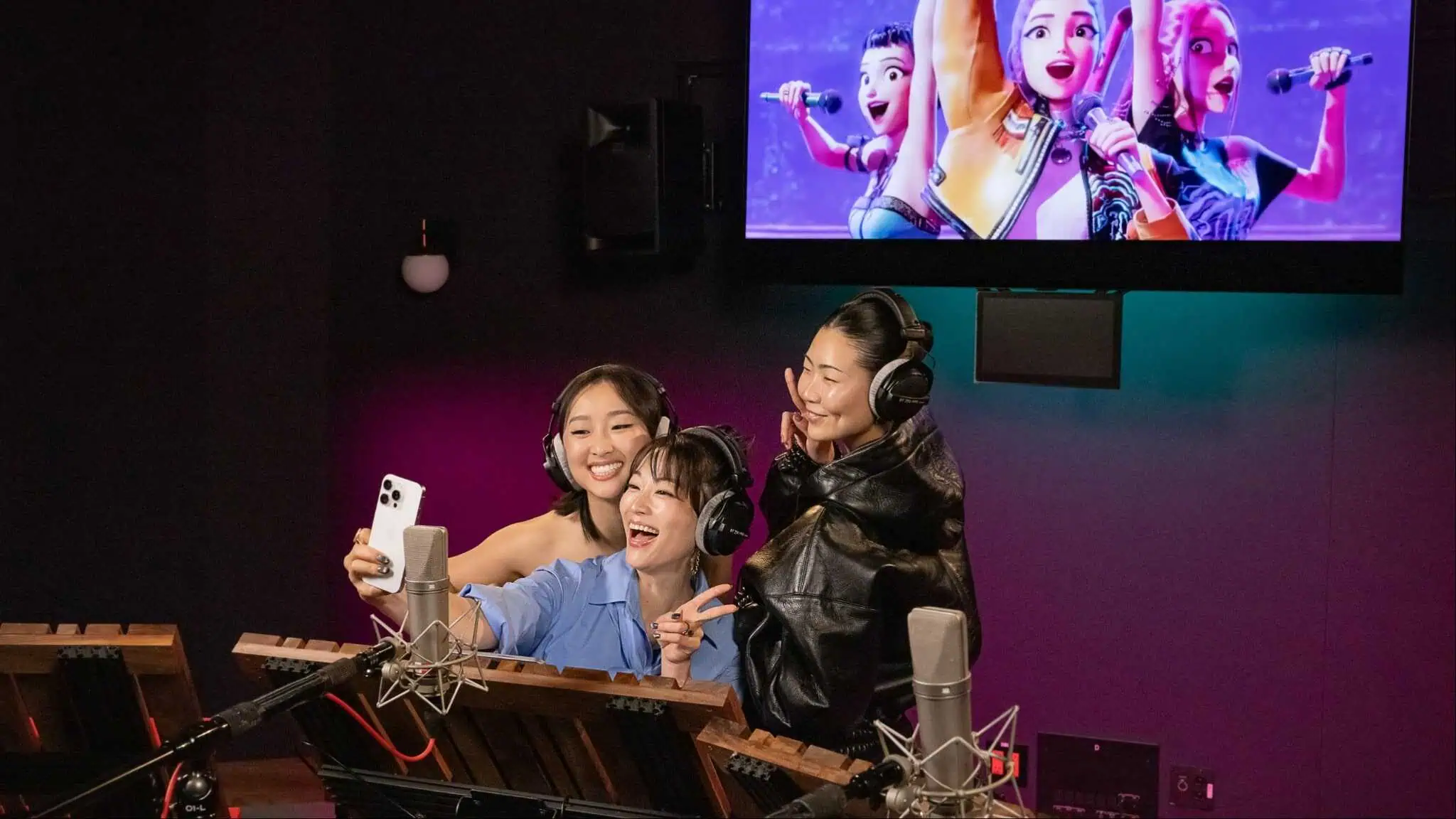 Arden Cho, May Hong and Ji-Young Yoo in a recording booth taking a selfie.