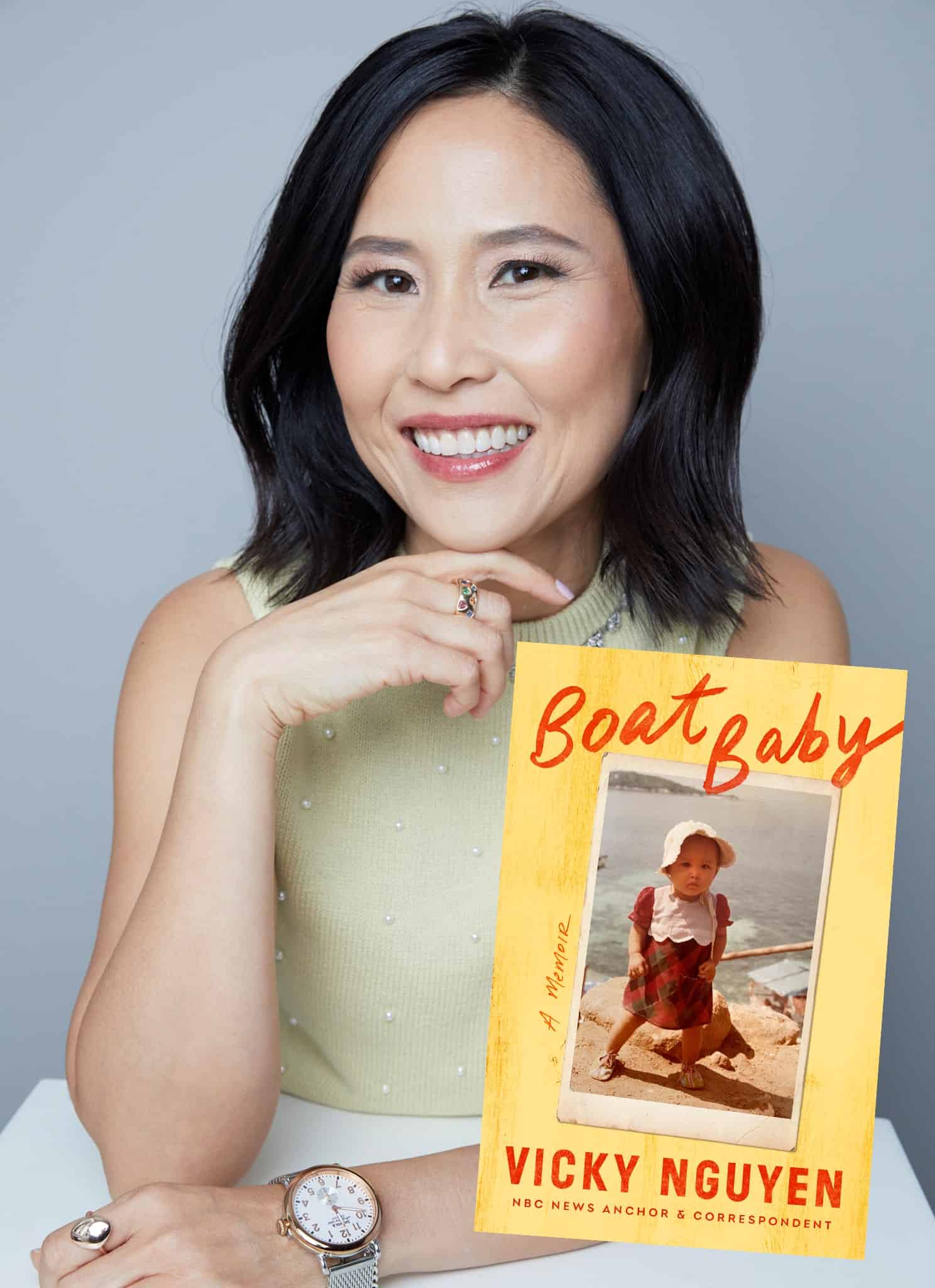 Vicky Nguyen smiling for the camera with her book cover next to her.