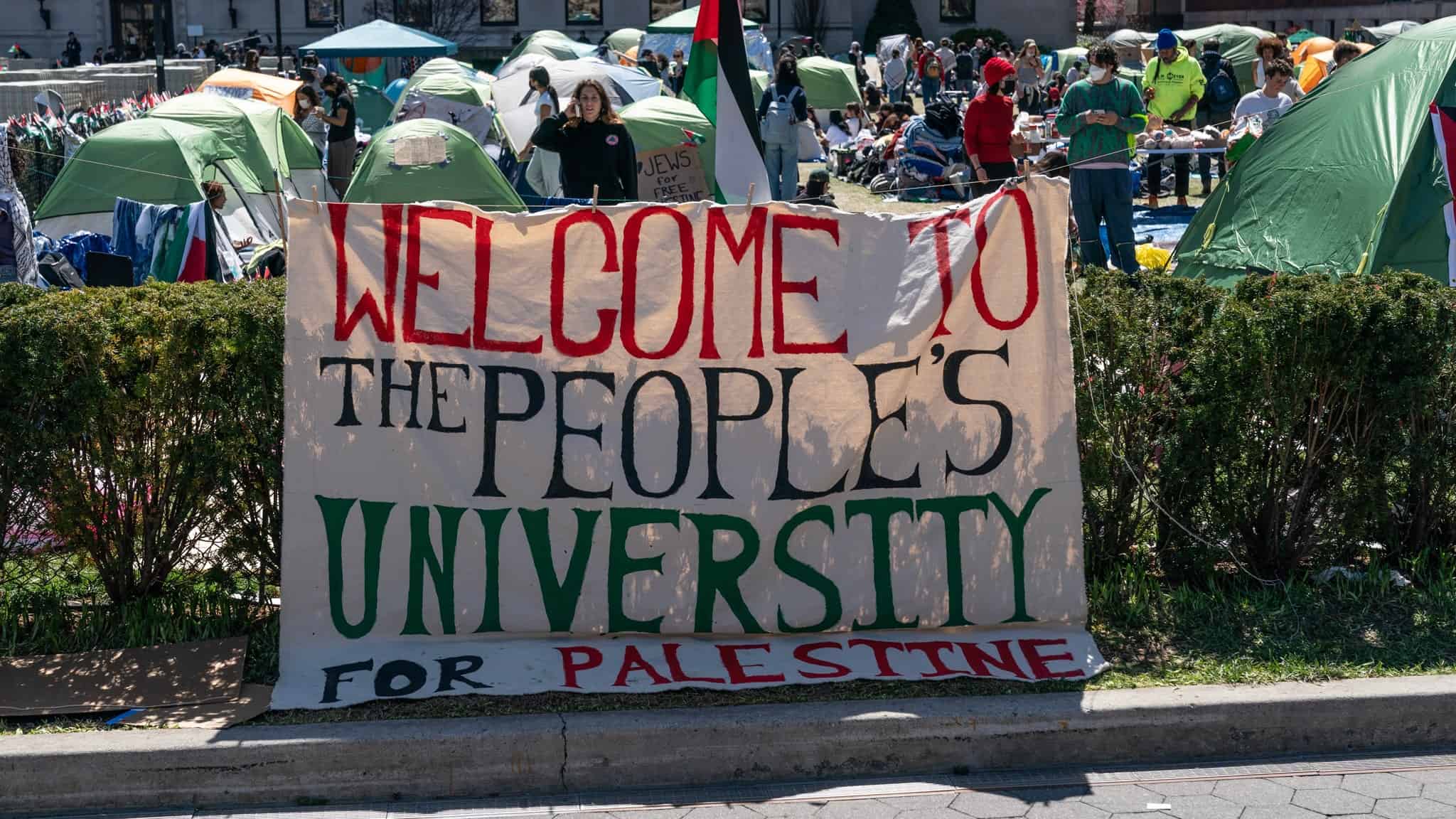 Pro-Palestinian supporters set up a protest encampment on the campus of Columbia University in New York as seen on April 22, 2024; a sign reads: "WELCOME TO THE PEOPLE'S UNIVERSITY FOR PALESTINE."