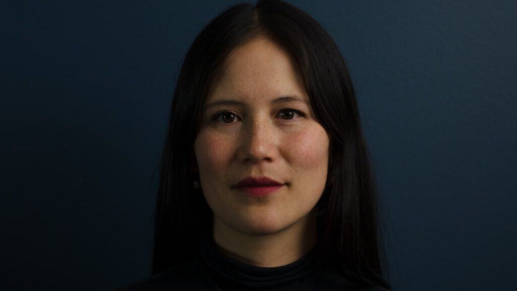 Gillian McKercher in front of a dark background.