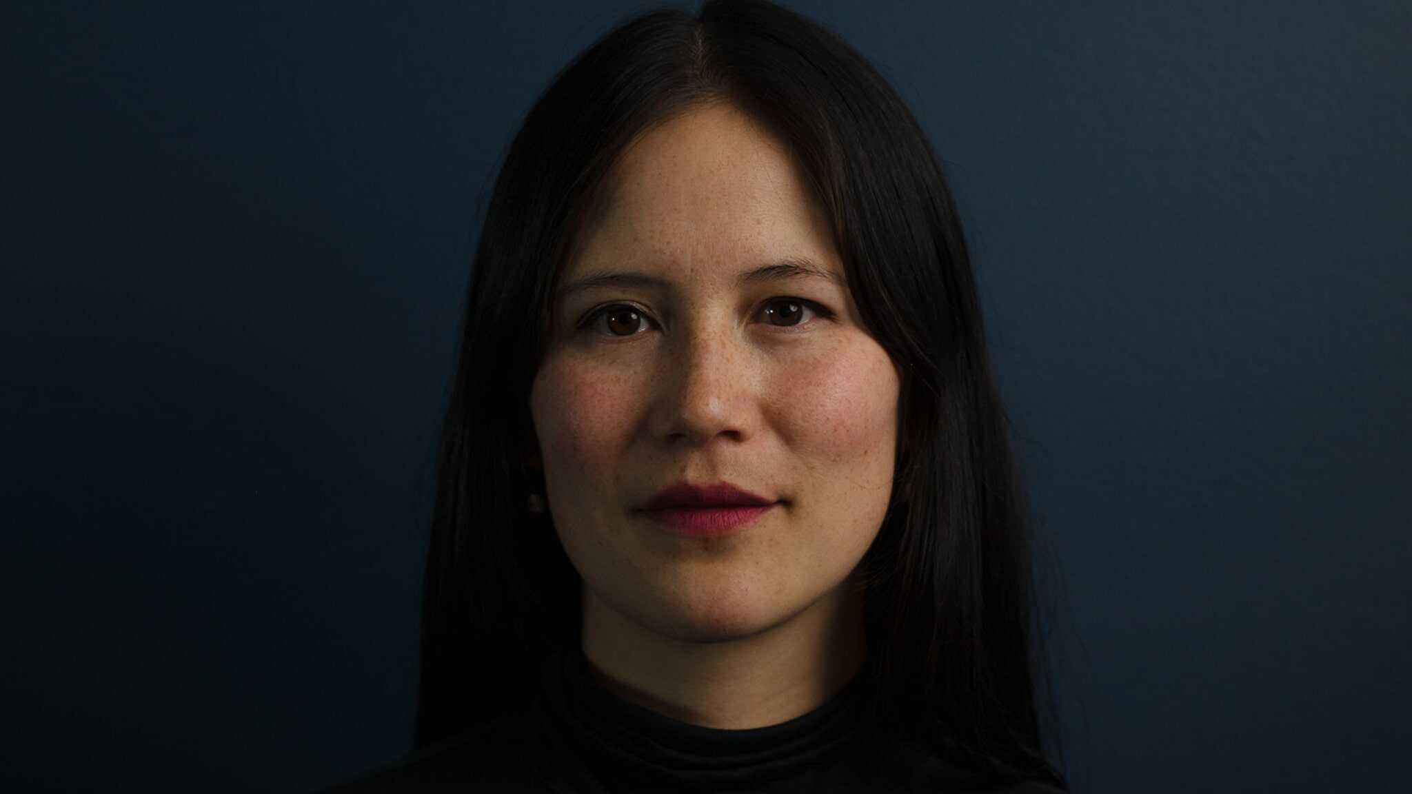 Gillian McKercher in front of a dark background.