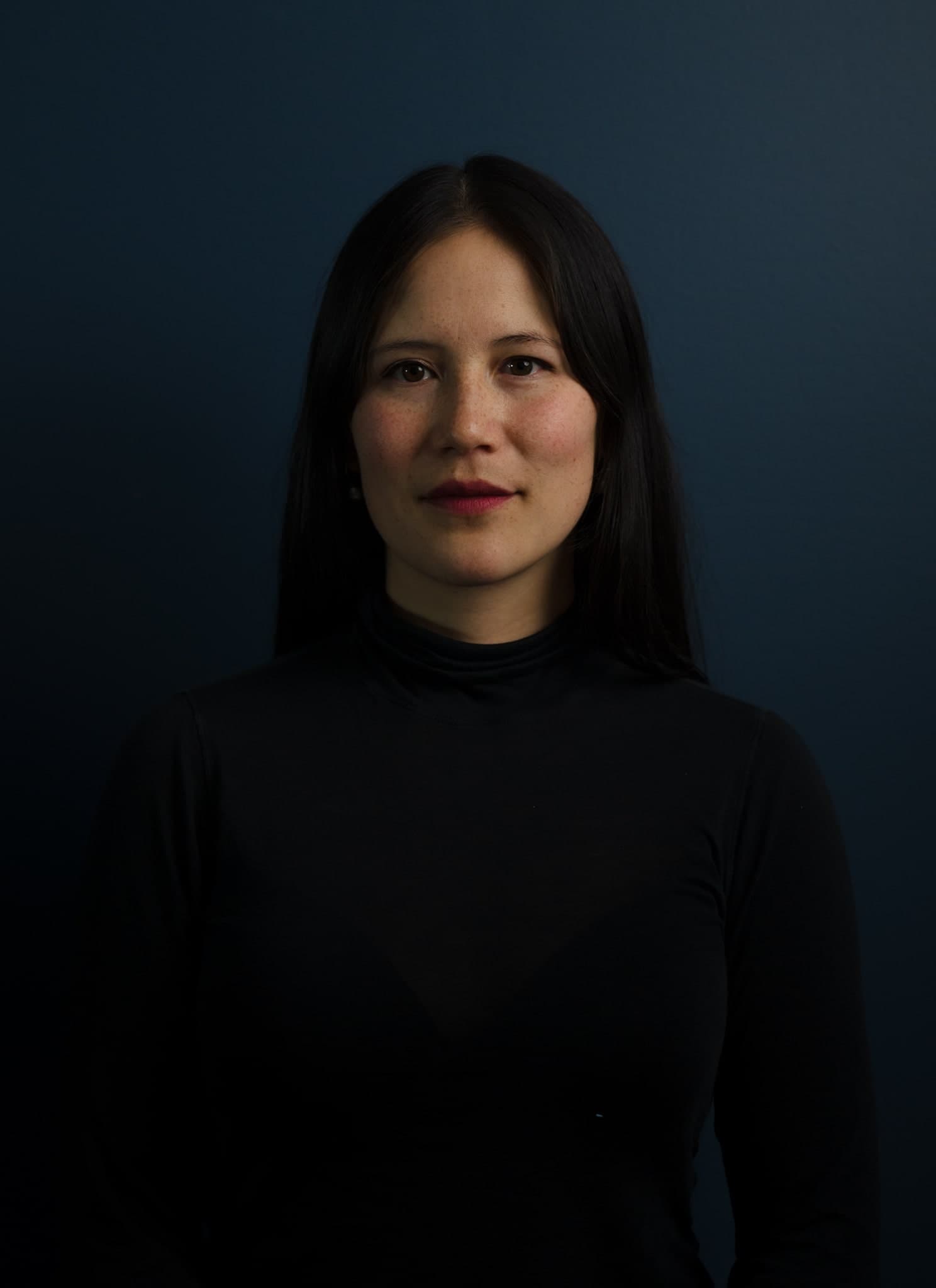 Gillian McKercher in front of a dark background.