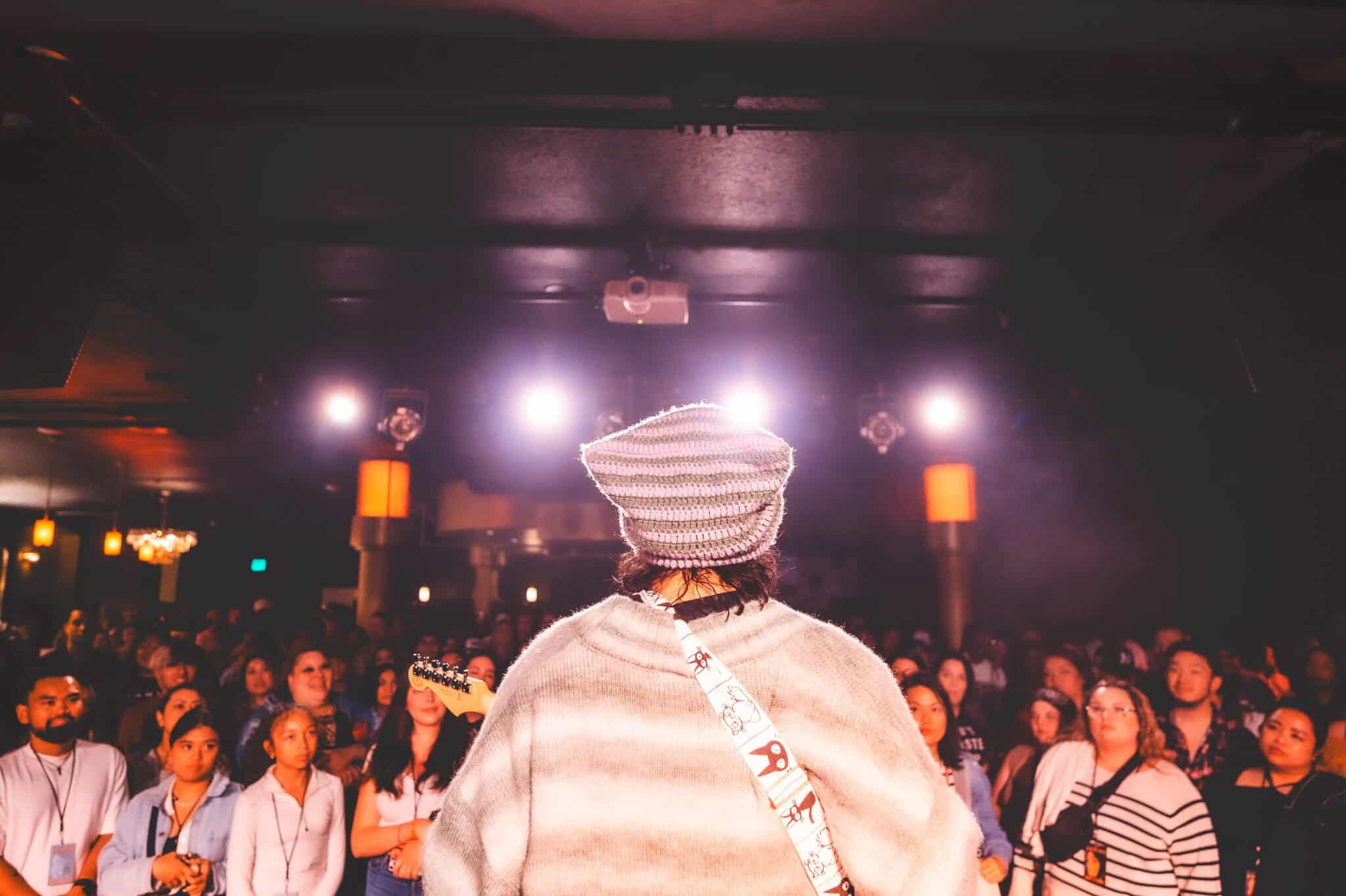 The back of LCN! as he performs for a crowd.