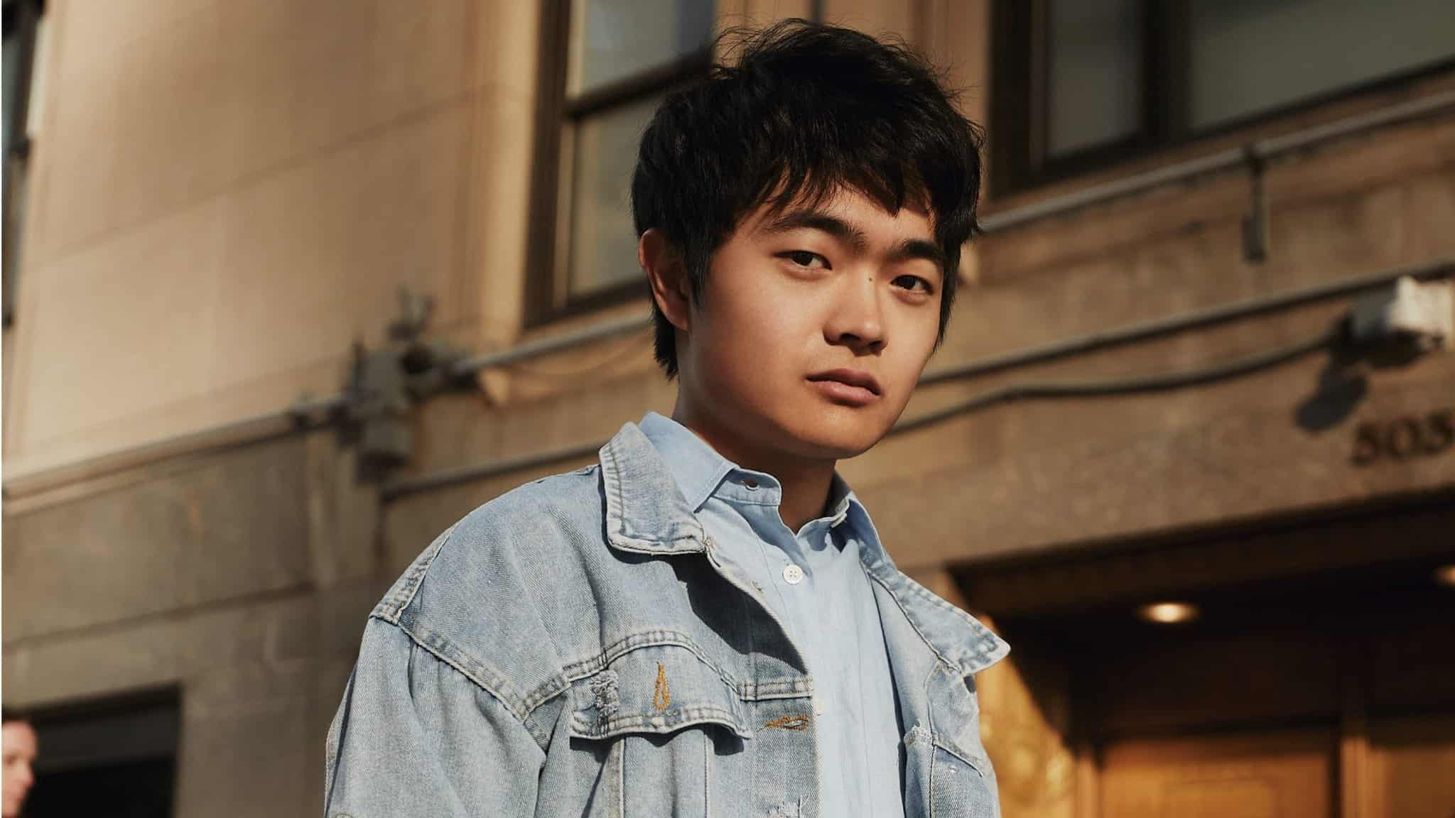 Ben Wang in blue dress shirt and jean jacket
