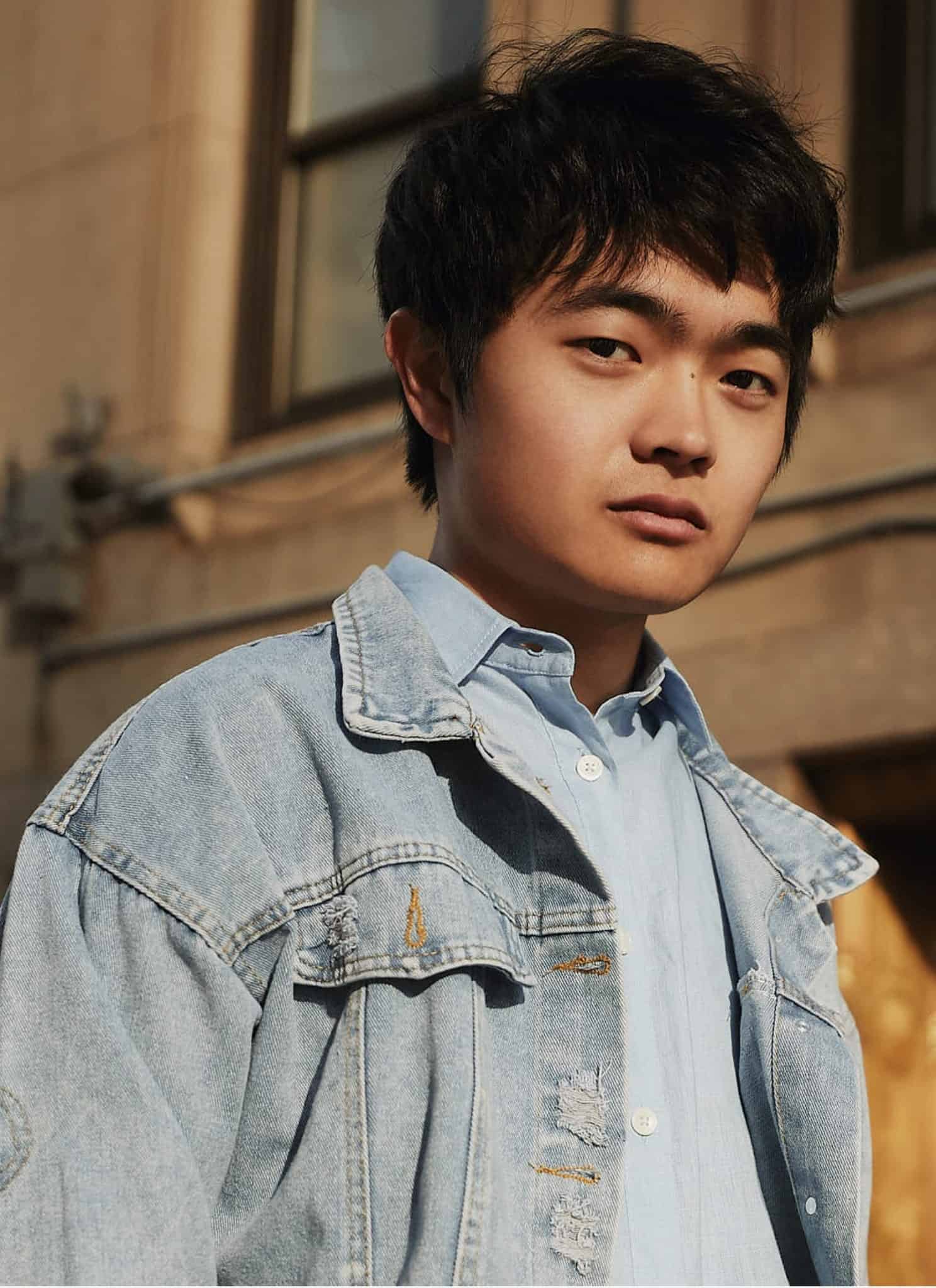 Ben Wang in blue dress shirt and jean jacket