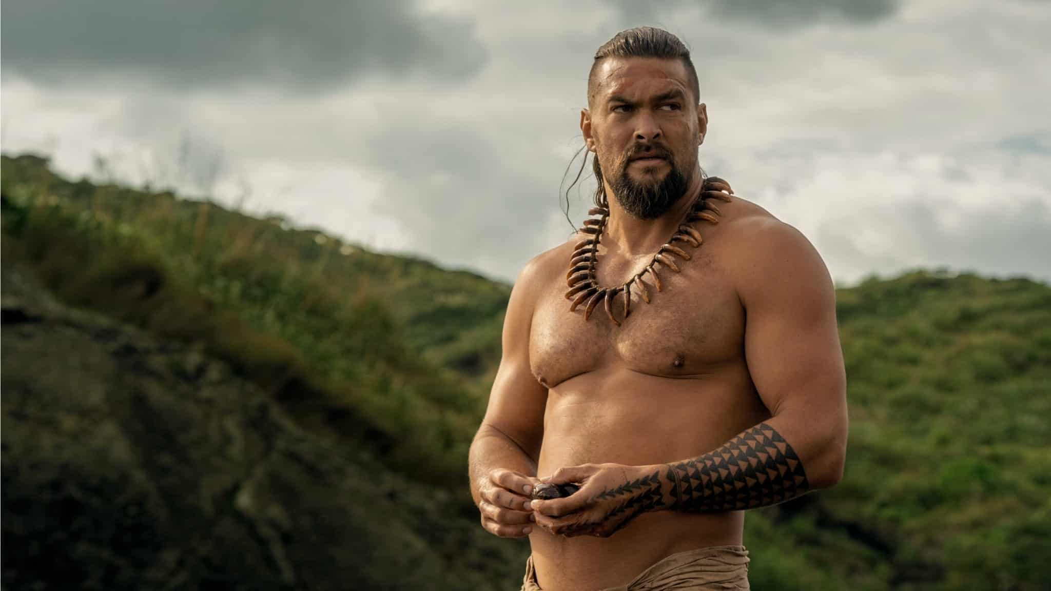 Jason Momoa as Ka’iana in Chief of War, standing shirtless.