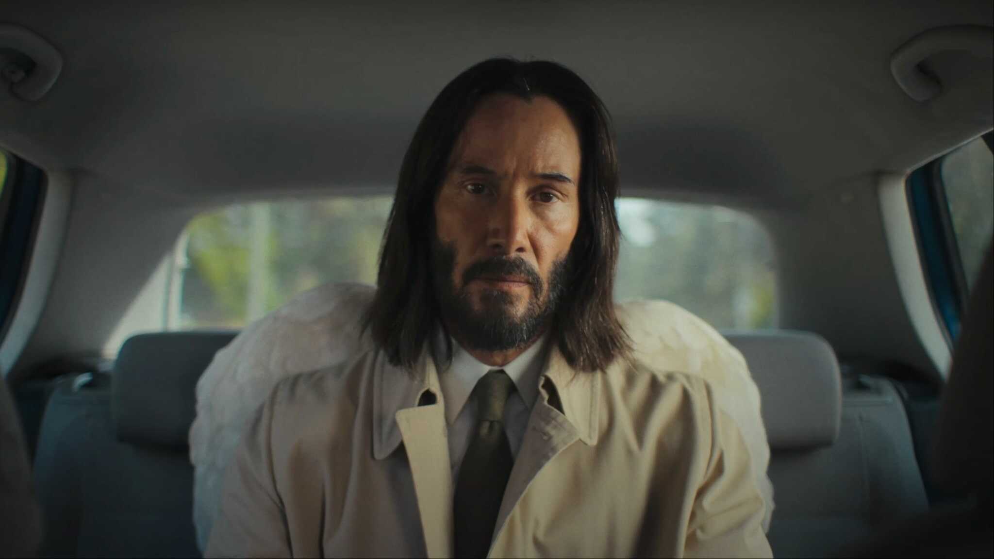 Keanu Reeves in white shirt and beige coat in Good Fortune trailer.