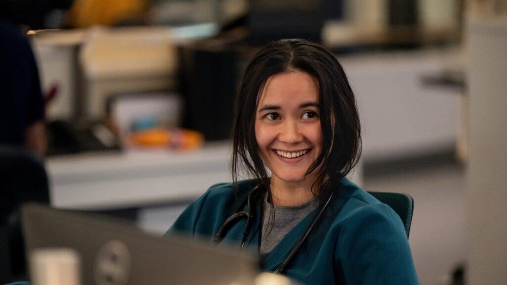 Actress Chelsea Muirhead in teal hospital scrubs on the show "Pulse."