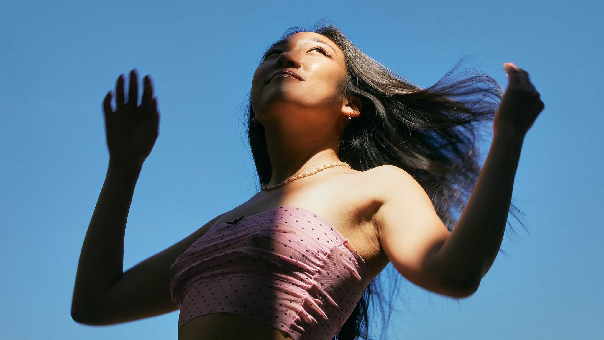 Anna Lee in front of a clear blue sky.