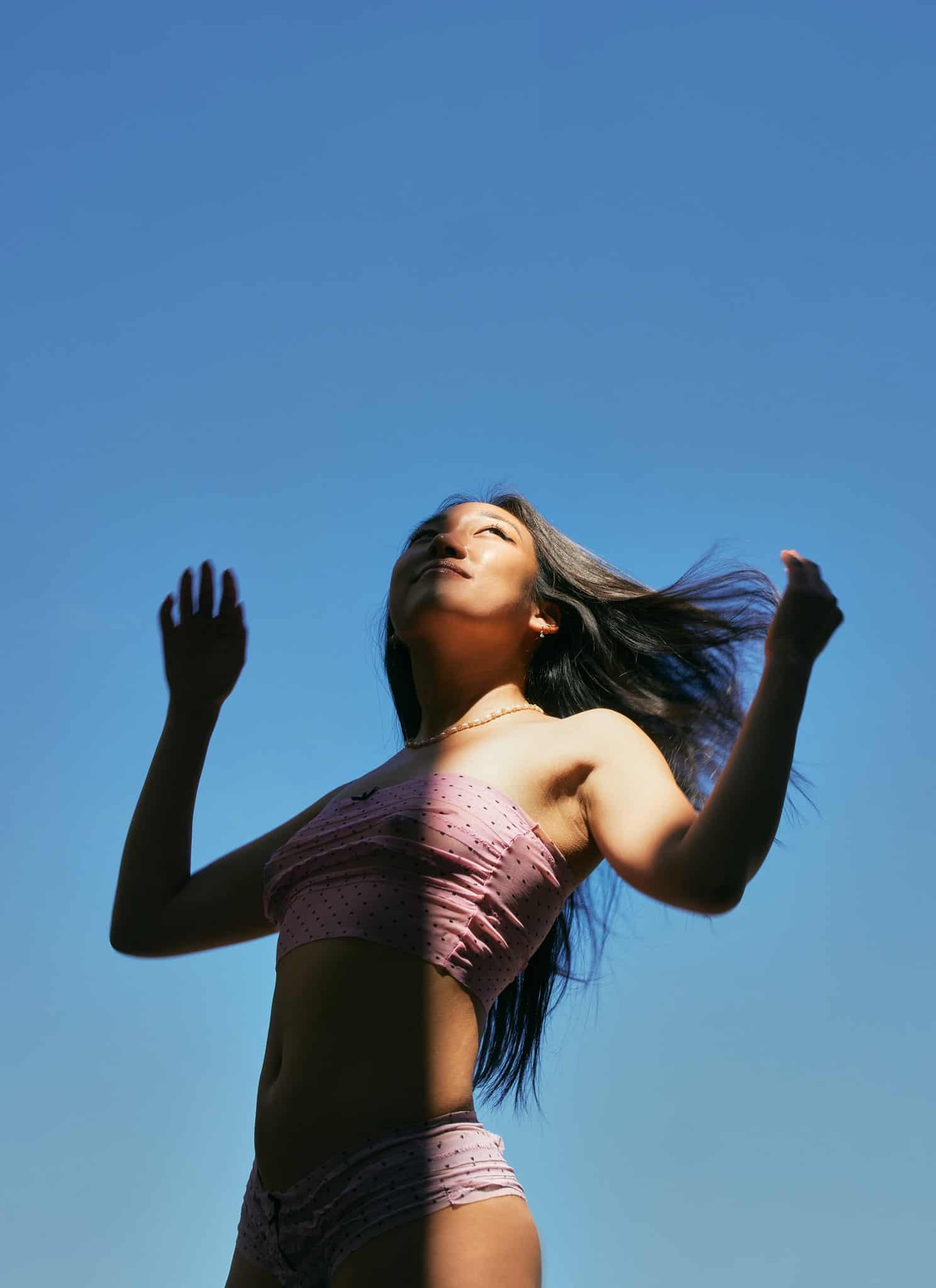 Anna Lee in front of a clear blue sky.