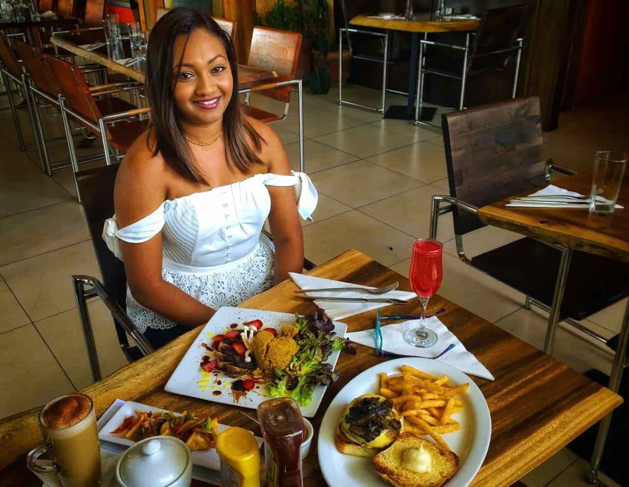 Natasha Laggan sitting at a table of food.