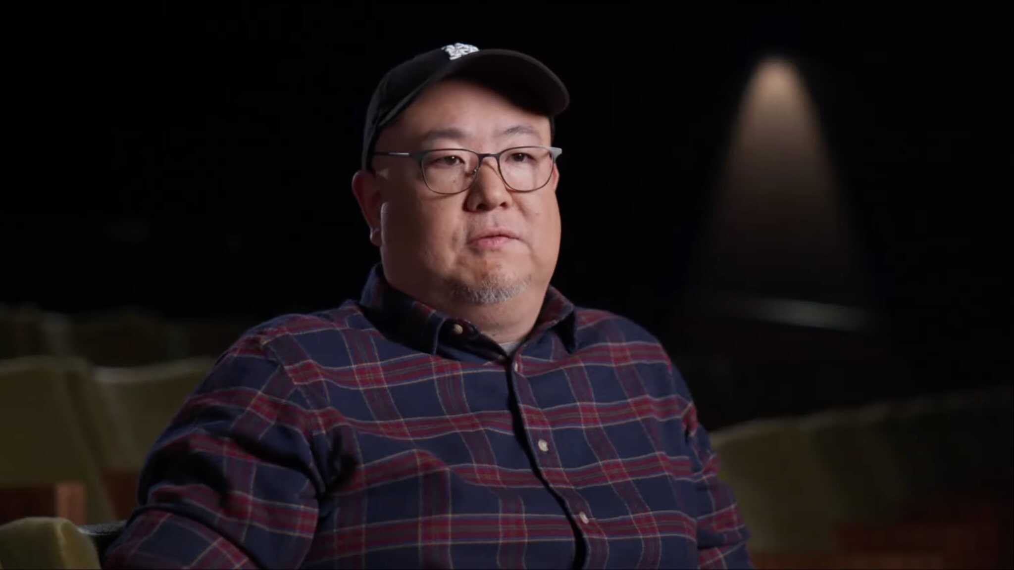 Peter Sohn sitting with black cap and flannel shirt.