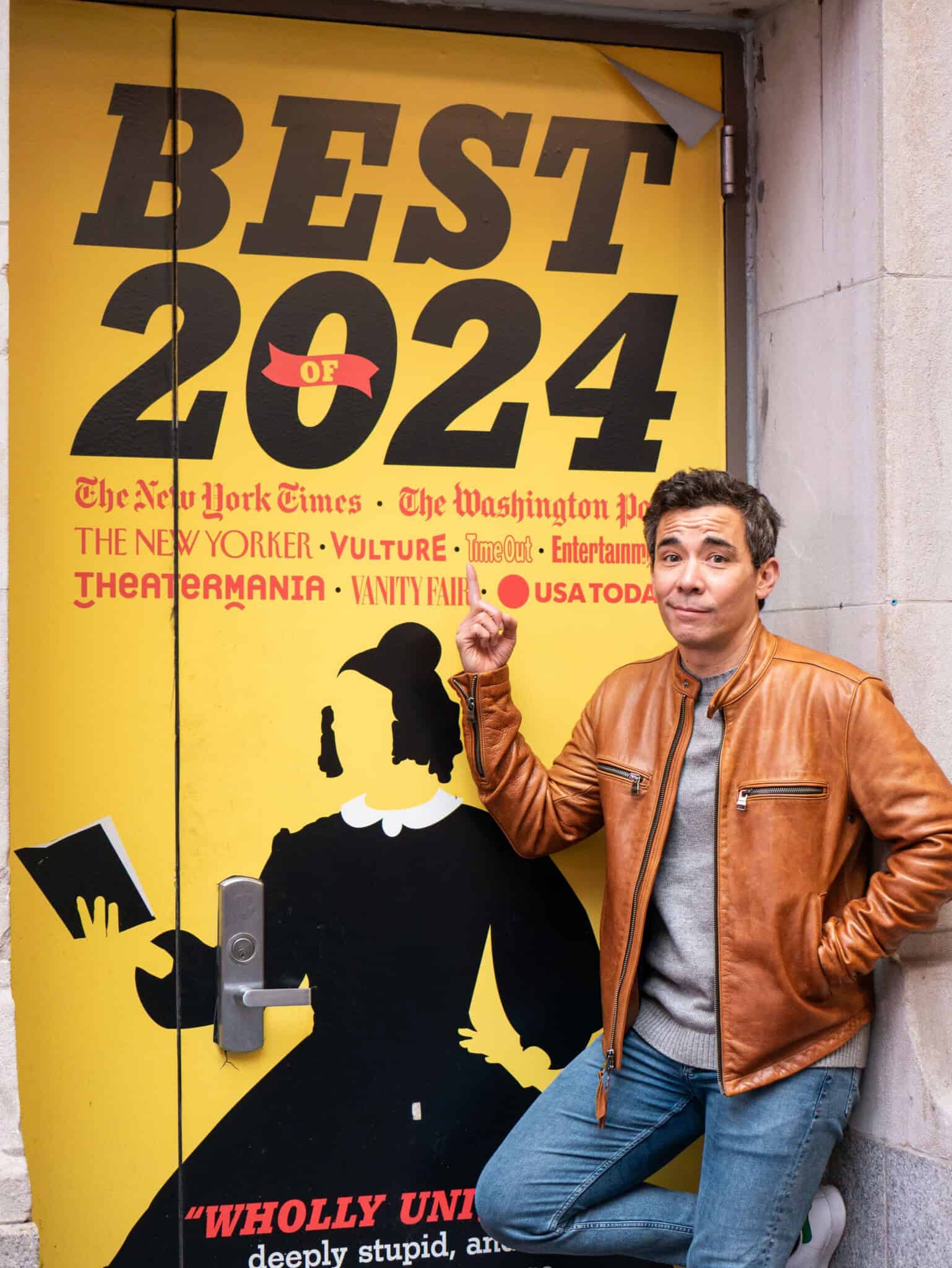 Actor Conrad Ricamora leans against a wall that reads “Best of 2024.”