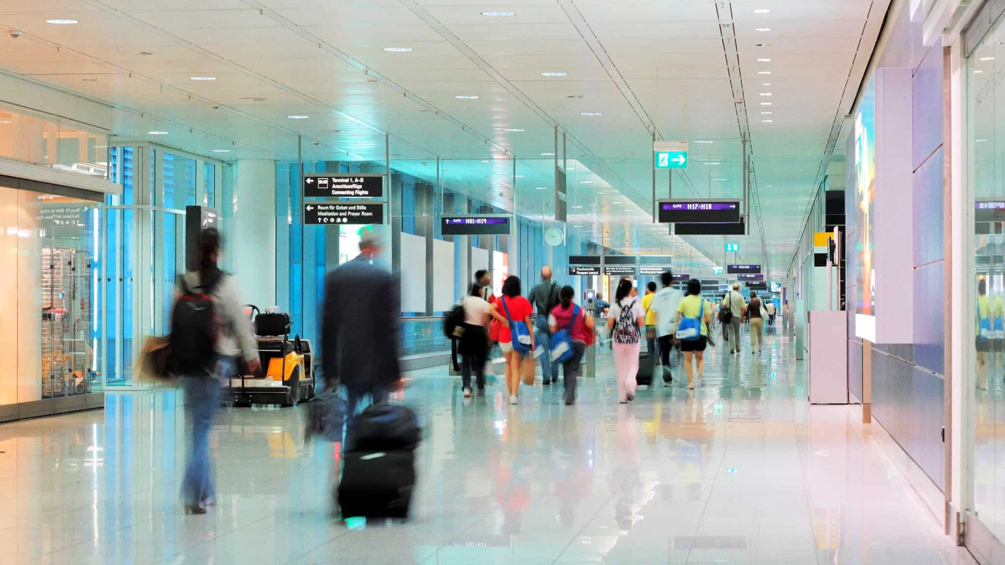 People walking through an airport.