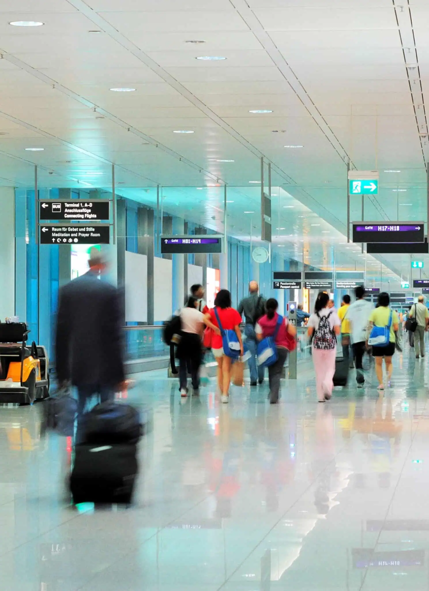 People walking through an airport.