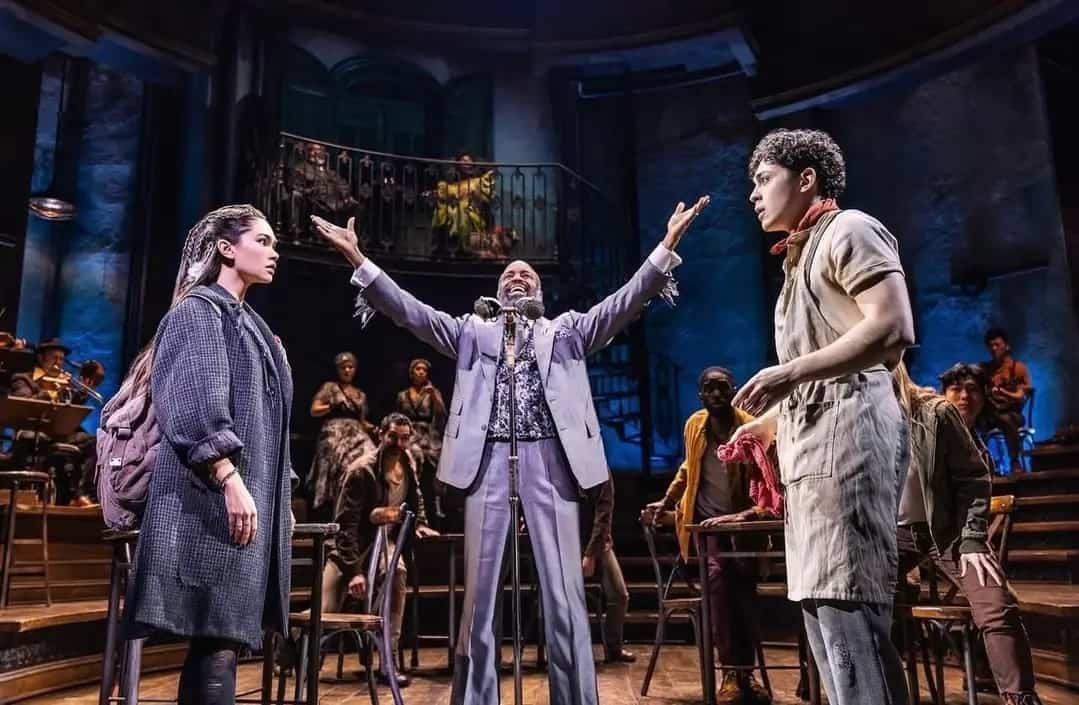 Myra standing across from Ali Louis Bourzgui as Orpheous with Phillip Boykin as Hermes in the middle.