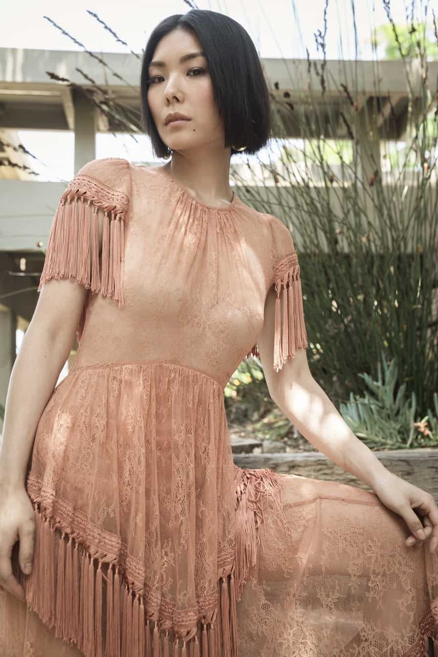 MASUMI in a beige dress.