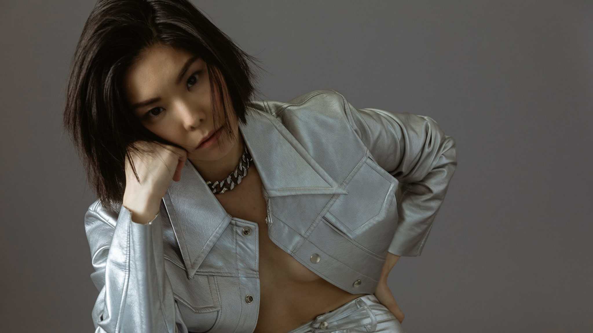 MASUMI wearing a shiny silver outfit.