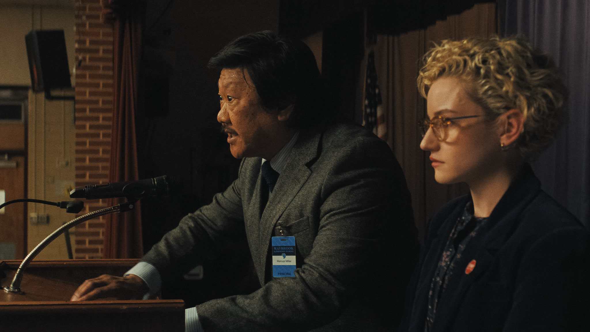 Benedict Wong as Principal Marcus and Julia Garner as Justine in Zach Cregger’s 