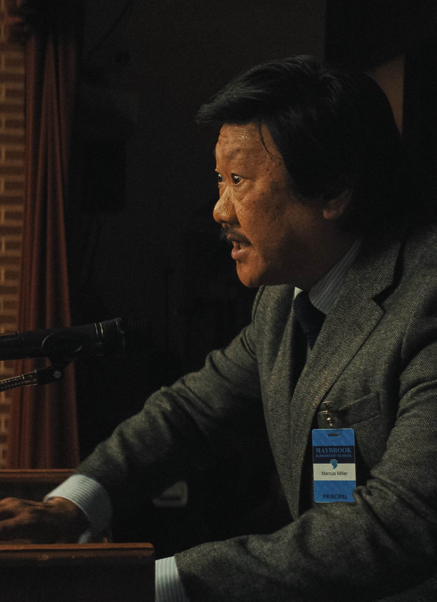 Benedict Wong as Principal Marcus and Julia Garner as Justine in Zach Cregger’s "Weapons."