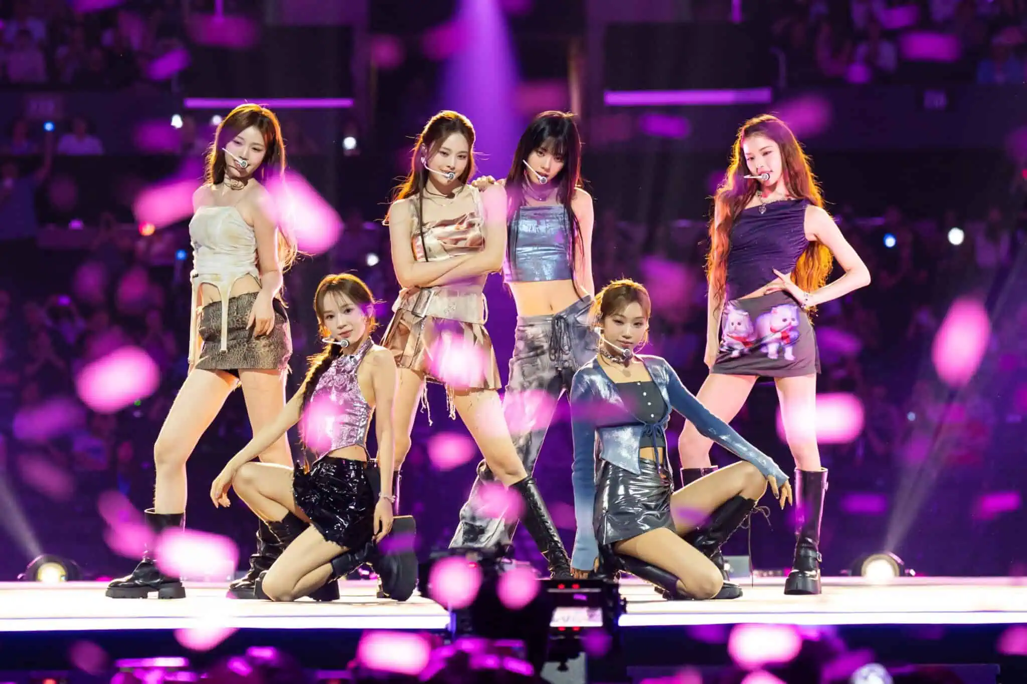izna posing together on stage at KCON LA 2025.
