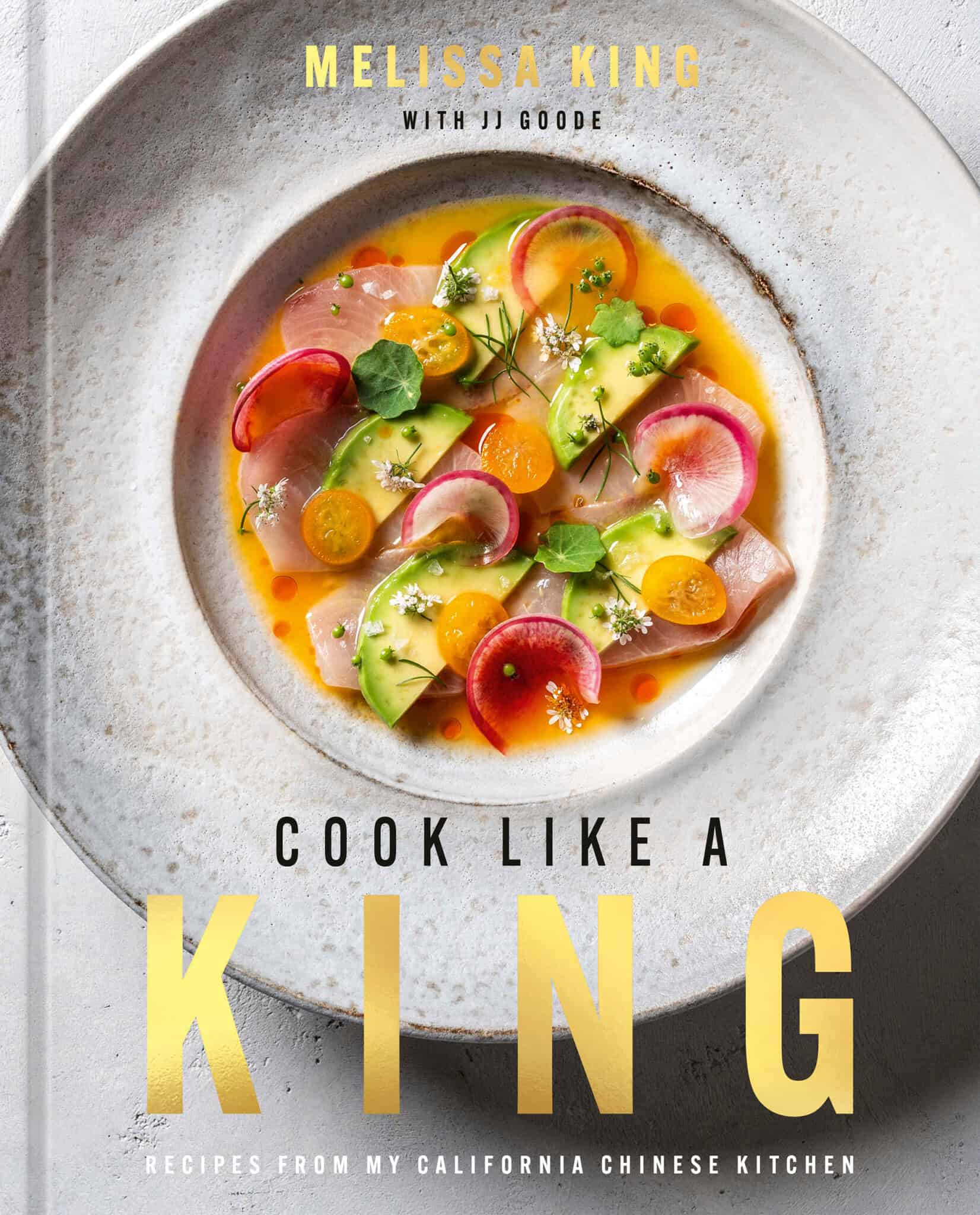The cover of a cookbook titled Cook Like a King by Melissa King features a vibrant dish of sliced colorful vegetables and herbs arranged in a light sauce on a white plate, set against a neutral background.