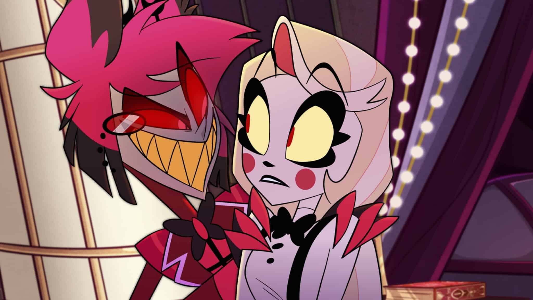 Two animated characters stand close together. The character on the left has red skin, sharp teeth, black and red hair, and glowing red eyes. The character on the right is white with yellow eyes, blush marks, and a bowtie, looking surprised.
