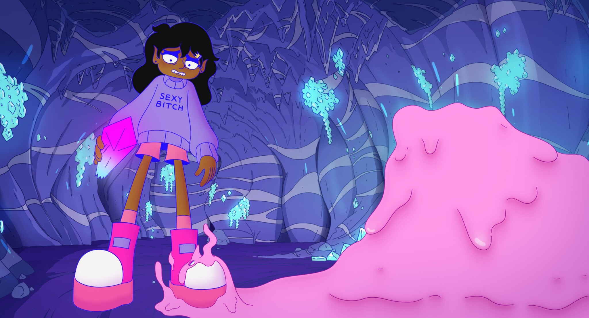 A cartoon girl in an oversized sweater that says SEXY BITCH stands in a glowing cave, holding a pink box. She looks worried as pink slime covers her foot and spills nearby. Blue crystals hang from the cave walls.