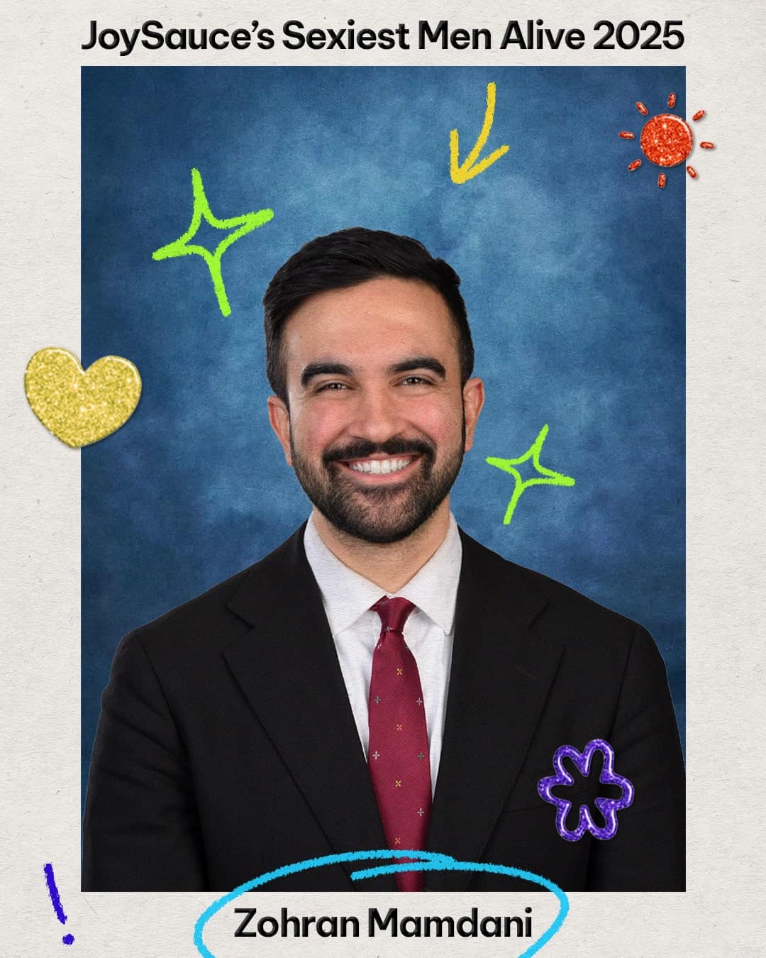 A smiling man in a suit and red tie poses in front of a blue backdrop, decorated with colorful doodles and a gold heart, celebrating JoySauce’s Sexiest Asian Pacific Islander Men Alive 2025. The name “Zohran Mamdani” appears at the bottom.