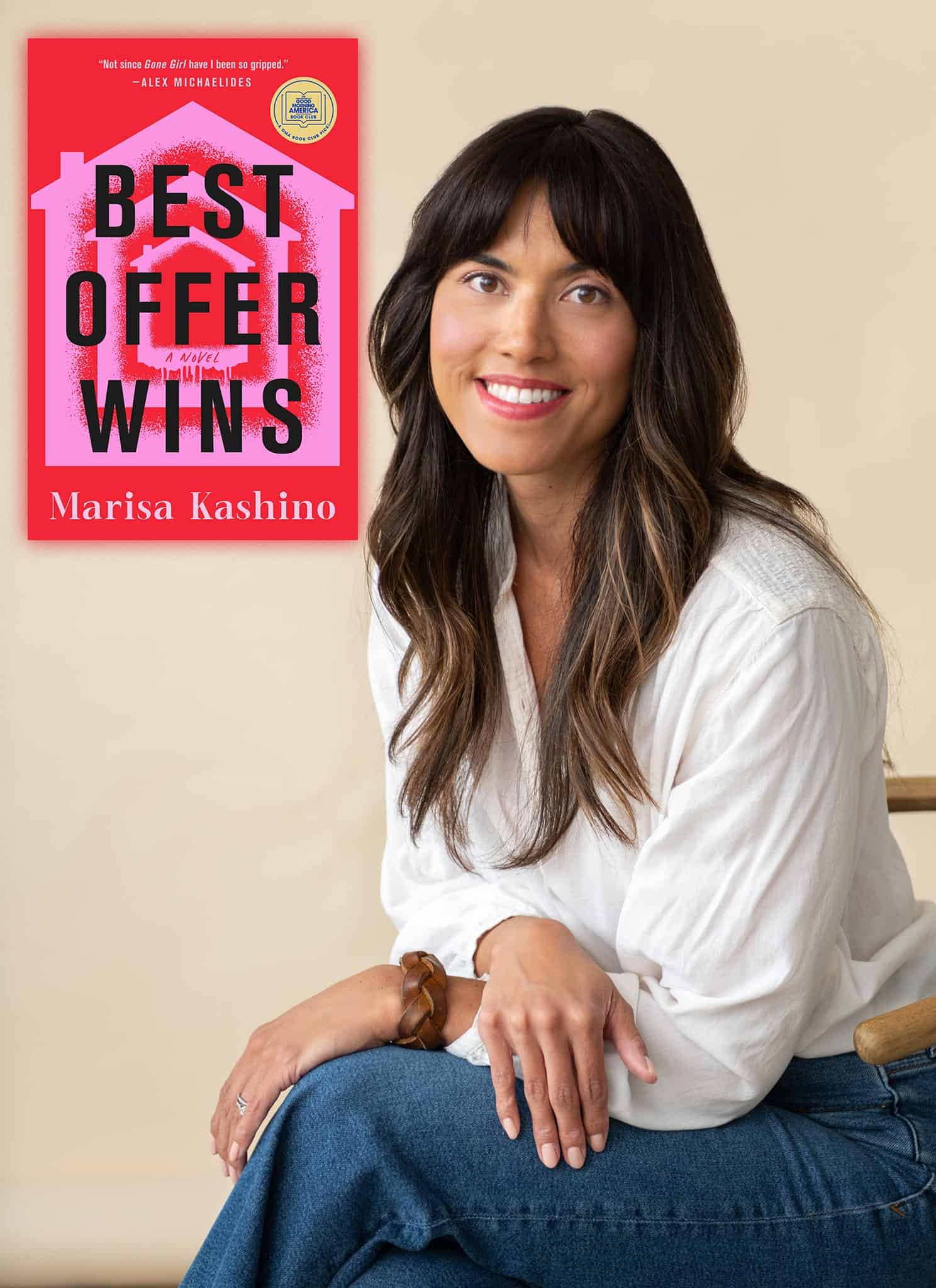 A smiling woman with long dark hair and bangs sits on a chair next to the cover of a book titled Best Offer Wins by Marisa Kashino, which features bold black and white text on a bright pink background.