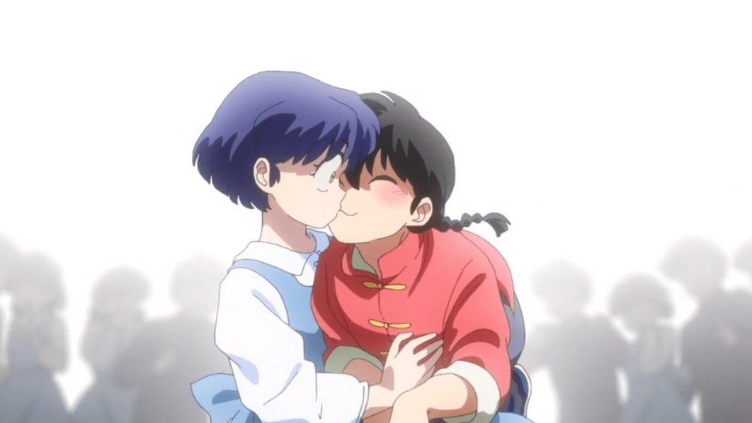 Two anime characters, one with short blue hair and the other with black hair in a braid, share a kiss. The background is white with faint silhouettes of people watching.