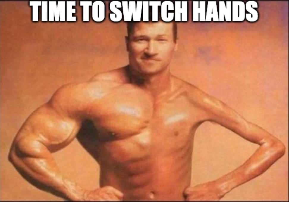 A muscular, shirtless man with an exaggeratedly large right arm stands with hands on hips. The text at the top reads, TIME TO SWITCH HANDS.