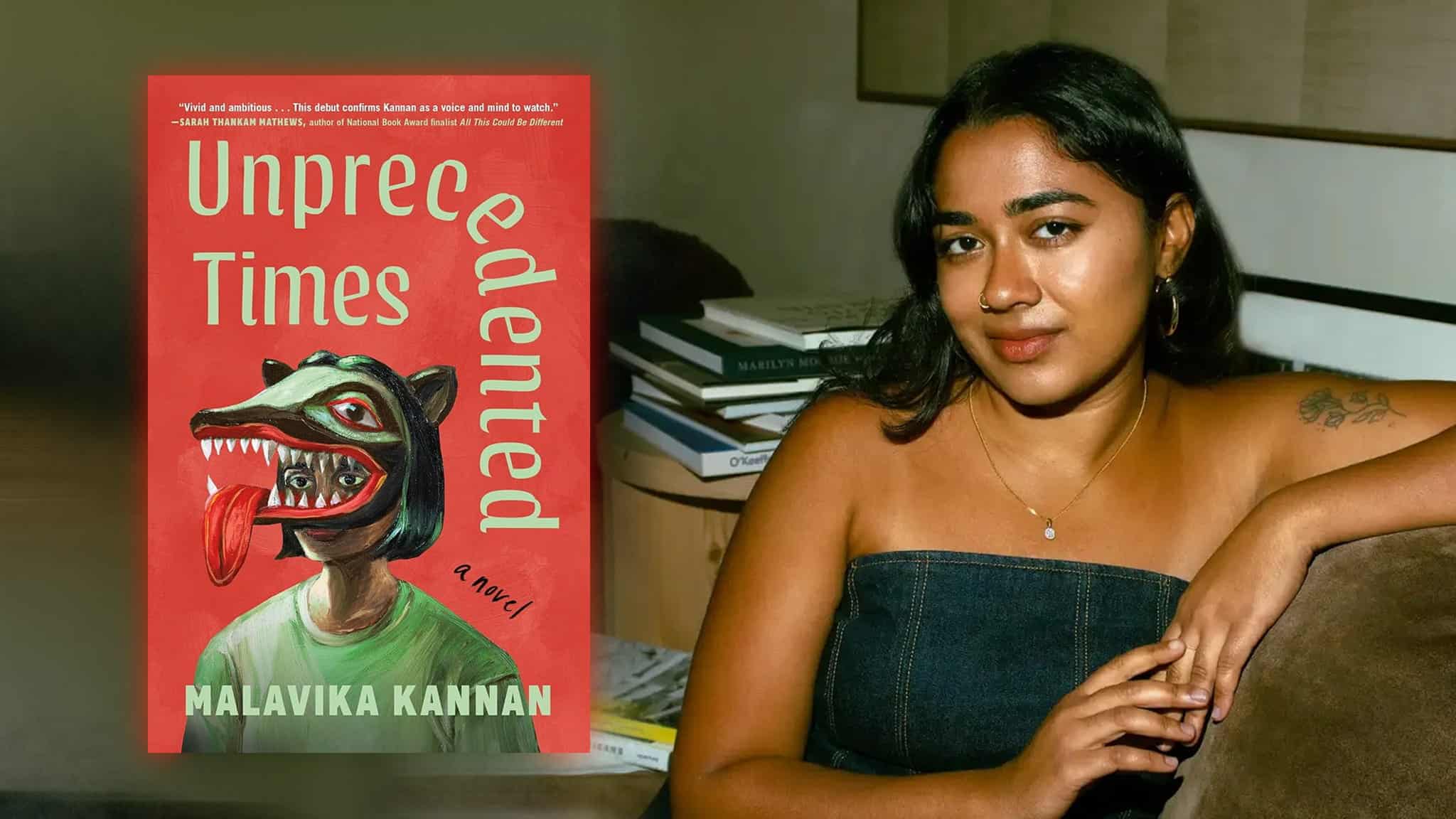 A woman sits beside a stack of books, next to the cover of the novel Unprecedented Times by Malavika Kannan, which features a stylized illustration of a person wearing an animal mask.