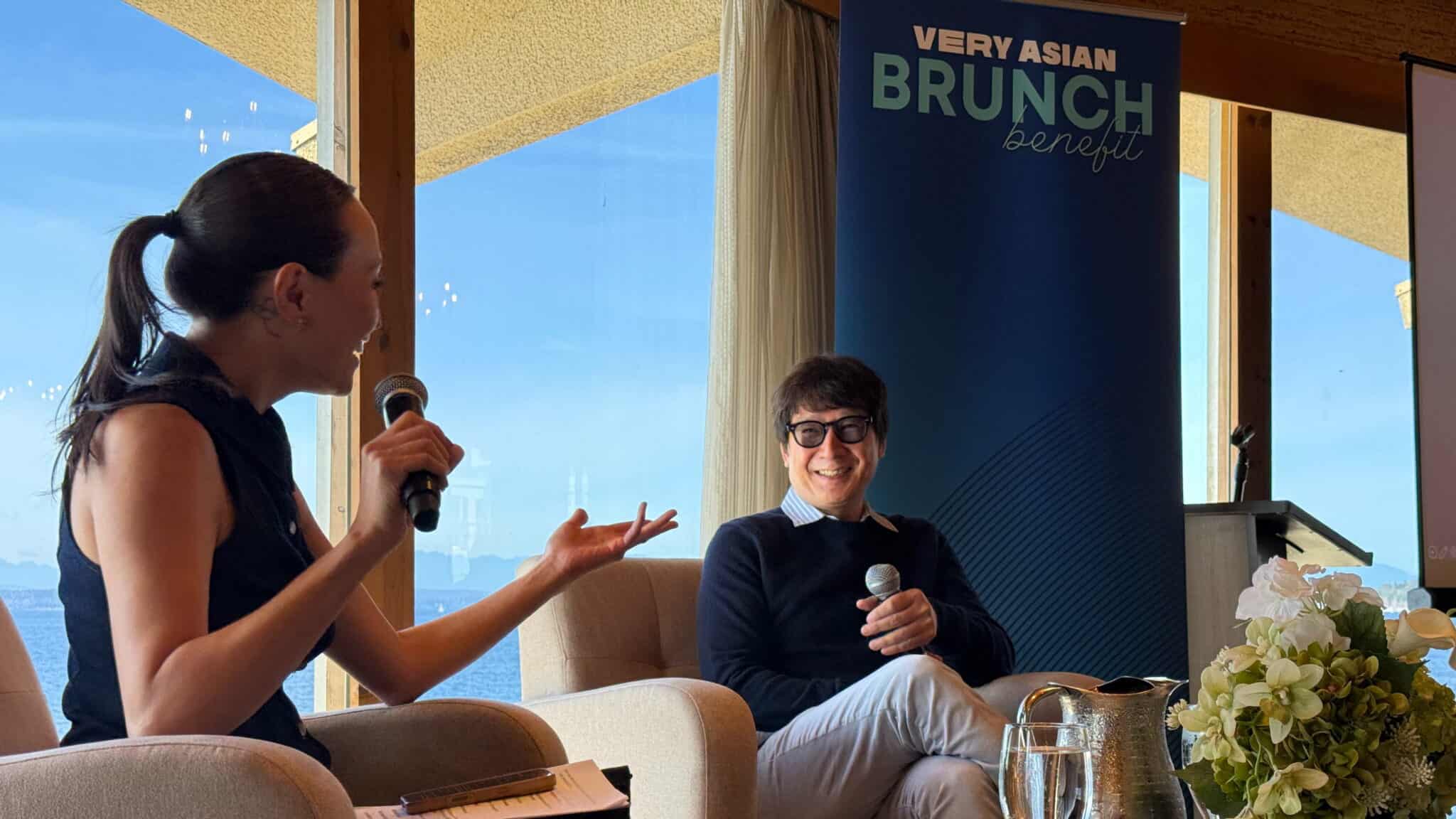 A woman interviewing a man on stage at a Very Asian Brunch benefit event.
