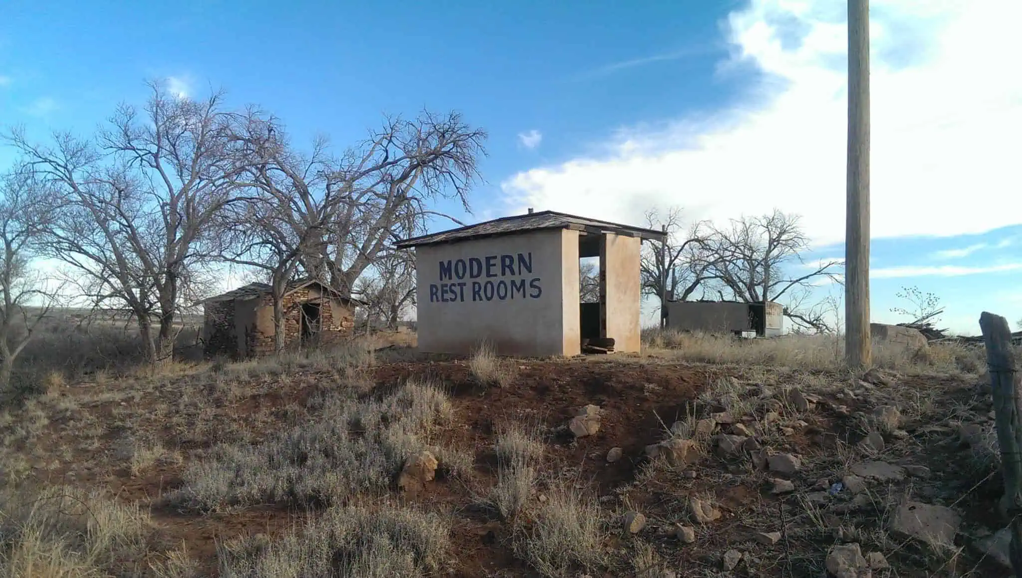 a falling cabin and the two-seater privy of Modern Restrooms