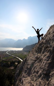 silhouette-of-a-female-rock-climber-with-outstretc-2025-01-09-04-05-40-utc