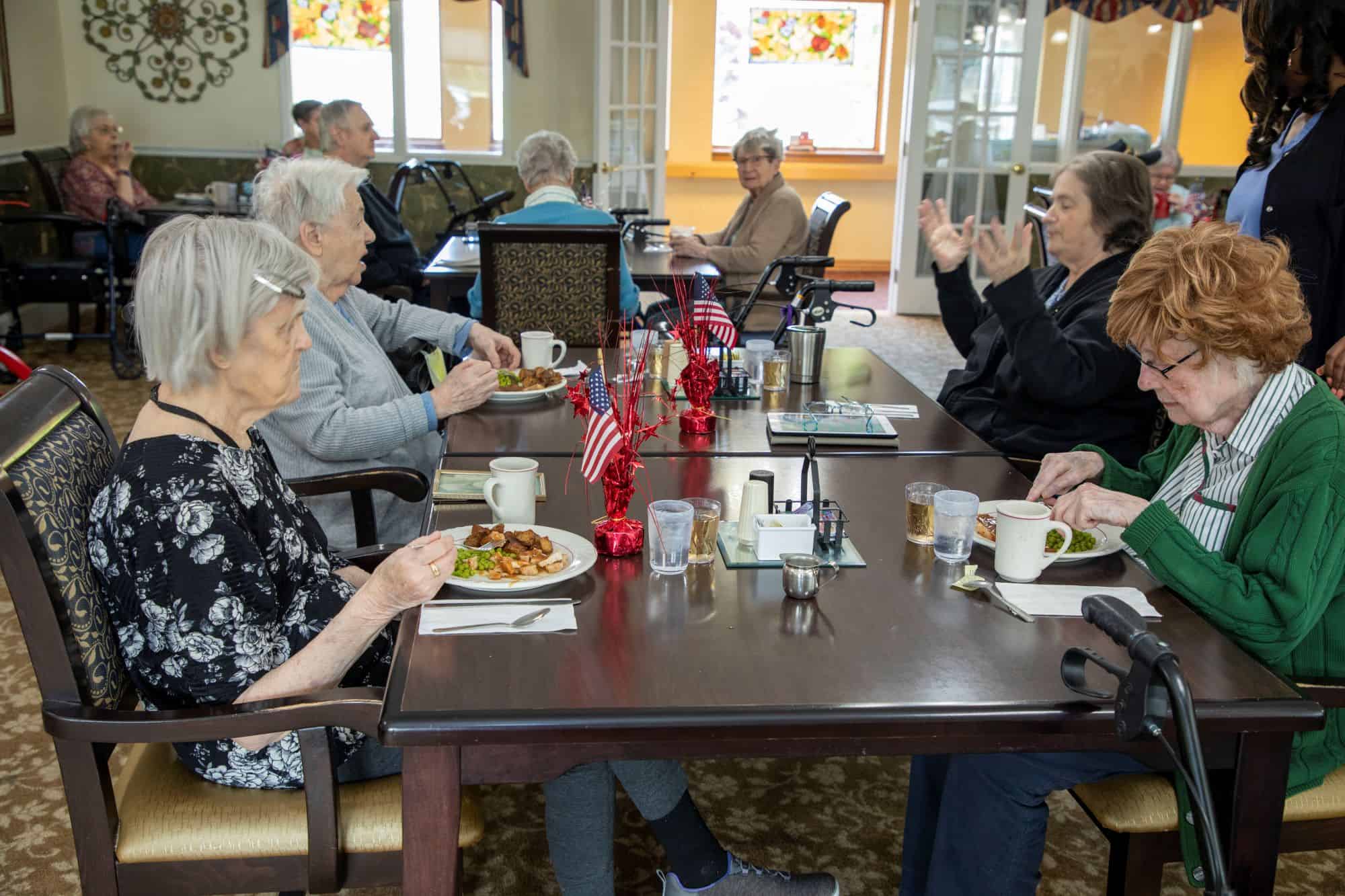 Elderly sitting down and eating breakfast
