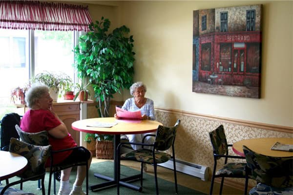 2 residents sitting around a table together
