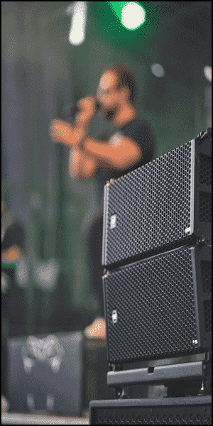 a man playing a guitar in front of a band.