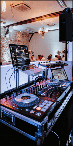 a dj set up with a laptop on top of it.