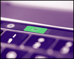 Close-up of a keyboard with a green illuminated key displaying a phone icon, suggesting a call or communication function—perfect for tech setups and unique gift ideas for DJs.