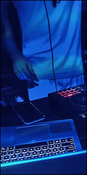 a person standing in front of a laptop computer.