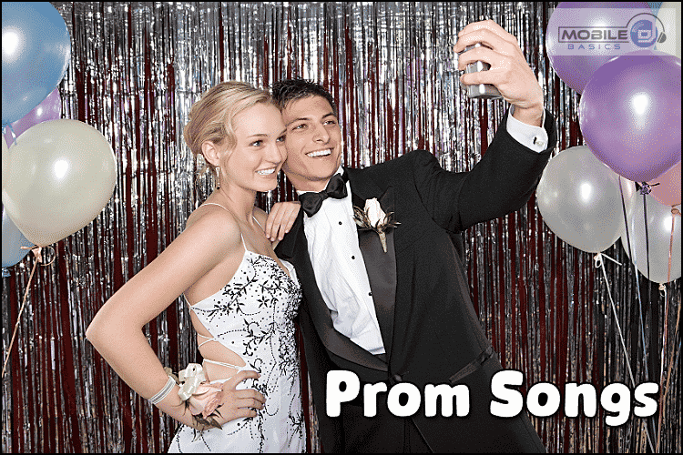 A young couple in formal prom attire takes a selfie in front of a silver tinsel backdrop with balloons; text on image reads "Prom Songs" to celebrate their unforgettable night.