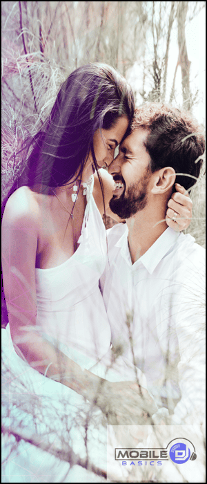 a man and a woman are kissing in the woods.