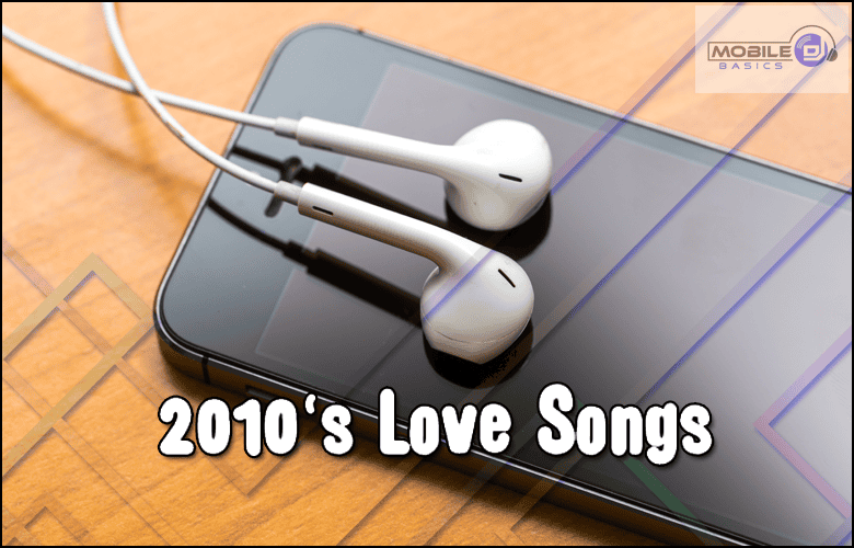 White earphones rest on a smartphone, featuring the text "Love Songs of the 2010's" across the image. The Mobile Basics logo is displayed in the upper right corner.