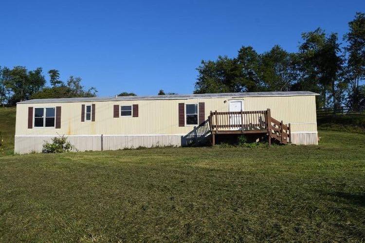 Single Wide mobile home before metal siding was painted