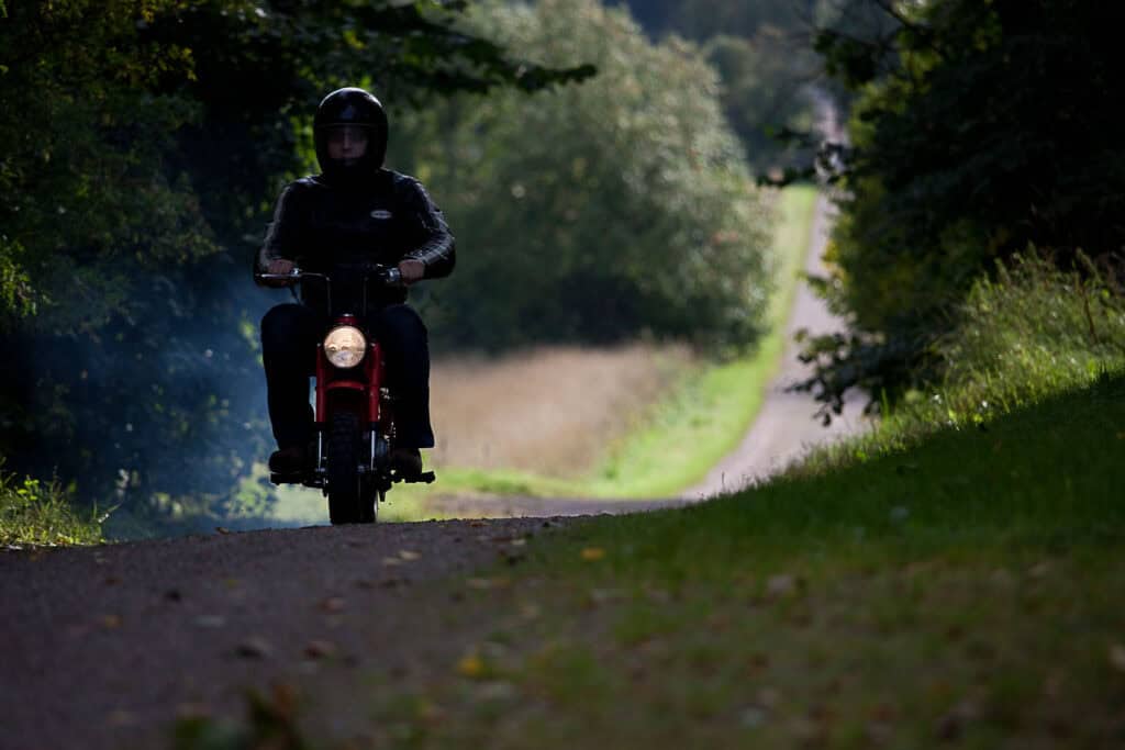 Riding a Honda Monkey on a sand road
