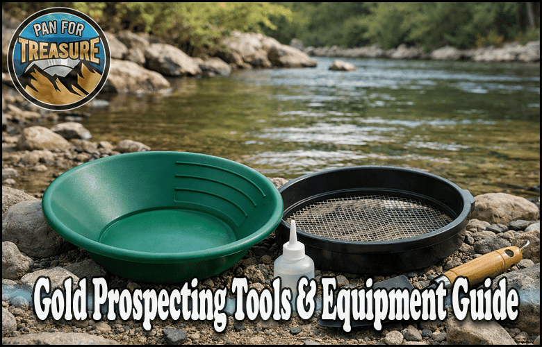 A green gold pan, a black sifting pan, a snuffer bottle, and a brush sit on rocks beside a river, showcasing essential Gold Prospecting Tools in this Equipment Guide.