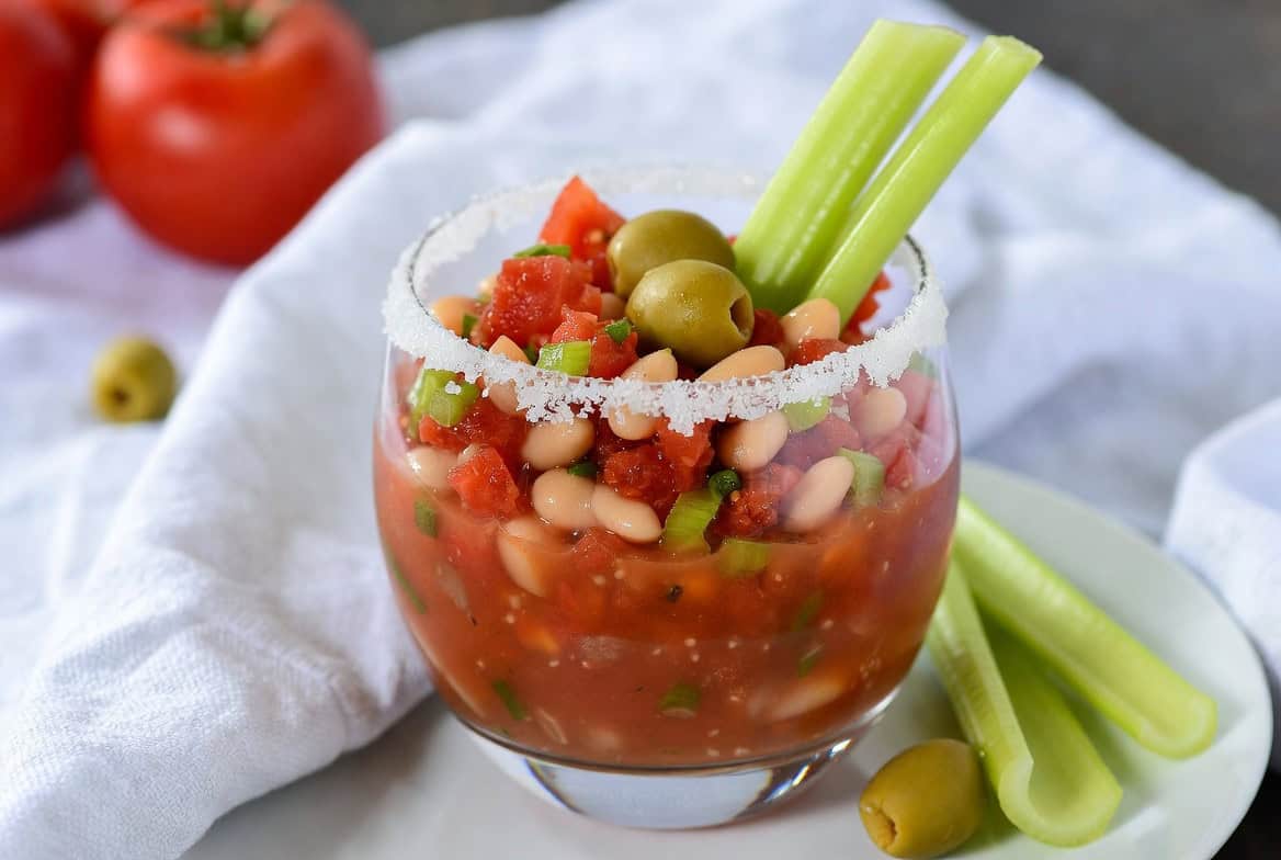 Tomato white-bean salad with olives celery and salt rim glass